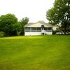 A view of the putting green with clubhouse in background at Harbor Hills Country Club