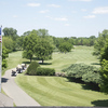 A view from the clubhouse with cart path on the left at Oakhurst Country Club