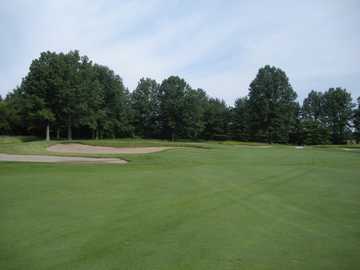 A view of the 4th green protected by bunkers at The Golf Club